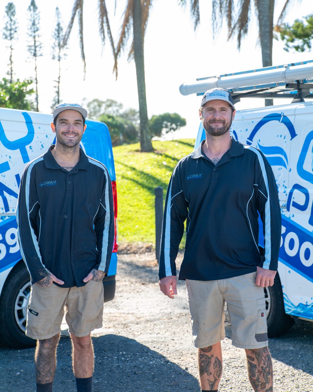 Cooly plumbers in front of the van